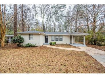 Charming single-story home with a well-maintained yard and covered parking area at 3511 Misty Valley Rd, Decatur, GA 30032