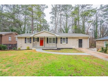 Charming single-story home with a well-manicured front yard, inviting walkway, and a pop of color with a red front door at 3527 Glenview Sw Cir, Atlanta, GA 30331