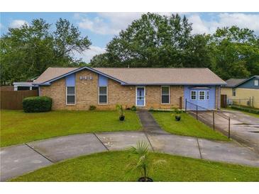 Charming brick home with blue accents, well-maintained lawn and circular driveway in a suburban neighborhood at 2818 Kensington Way, Rex, GA 30273