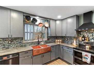 Updated kitchen featuring stainless steel appliances, custom cabinets, and copper farmhouse sink at 270 Cochran Ridge Rd, Dallas, GA 30157