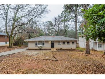 Charming single-story home with a brick facade and a well-maintained front yard at 3111 Flat Shoals Rd, Decatur, GA 30034