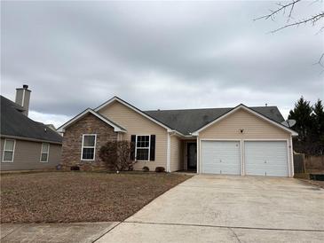 Charming single-Gathering home featuring stone accents and an attached two-car garage at 4976 Notting Glen Ln, Snellville, GA 30039