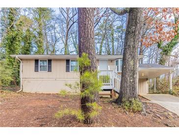Charming single-story home with a covered carport and inviting front porch at 2958 Flat Shoals Rd, Decatur, GA 30034
