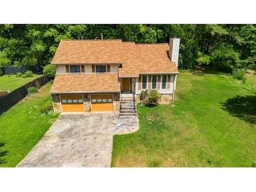 Charming two-story home with a two-car garage and a large, well-maintained yard at 4090 Welcome All Ter, Atlanta, GA 30349