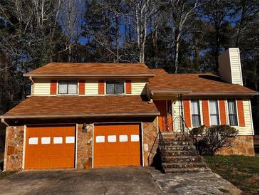 Charming two-story home with a unique blend of stone and siding, plus a two car garage at 4090 Welcome All Ter, Atlanta, GA 30349