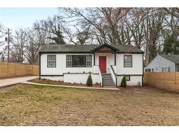 Charming home features a red front door, white siding, and a well-manicured lawn at 1459 Kenilworth Sw Dr, Atlanta, GA 30310