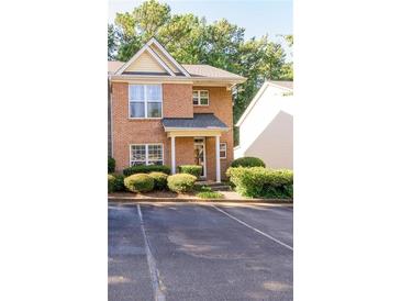 Charming brick home featuring a well-maintained front yard with lush greenery at 3831 Austin Park Ln, Decatur, GA 30032