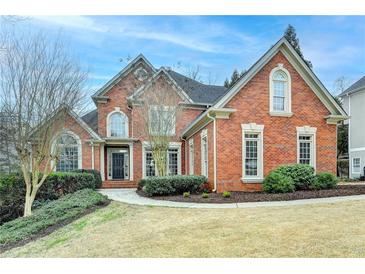 Beautiful two story brick home with manicured lawn and landscaping at 5990 Somerset Ct, Suwanee, GA 30024