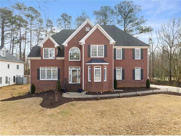 Charming brick home featuring a well-manicured lawn and inviting front entrance at 4391 Chatuge Dr, Buford, GA 30519