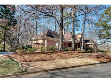 Charming single-story home featuring a side-entry garage and well-maintained landscaping at 1865 Berkeley Mews Ne, Atlanta, GA 30329