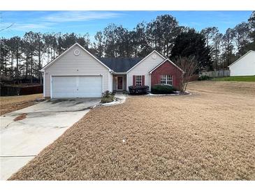 Charming single-Gathering home with a well-manicured lawn and attached two-car garage at 3151 Victoria Place Dr, Loganville, GA 30052