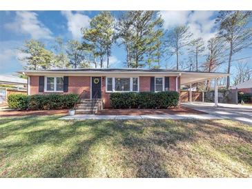 Charming single-story brick home featuring a covered carport, manicured landscaping, and a well-maintained lawn at 2187 Freydale Se Rd, Marietta, GA 30067