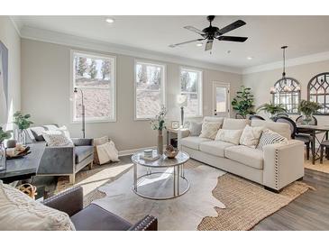 Bright living room featuring modern decor, hardwood floors, and large windows at 4537 Moray Dr, Mableton, GA 30126