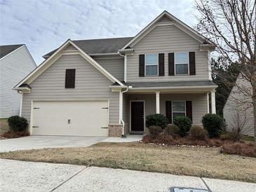 Charming two-story home with a two-car garage and a welcoming front porch at 7467 Saint David St, Fairburn, GA 30213