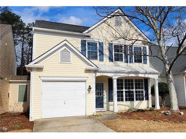 Charming two-story home with a covered porch, attached garage, and landscaped front yard at 65 Devonshire Dr, Alpharetta, GA 30022