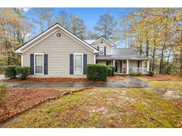 Charming single-Gathering home featuring a well-manicured lawn and welcoming front porch at 3900 Belle Glade Trl, Snellville, GA 30039