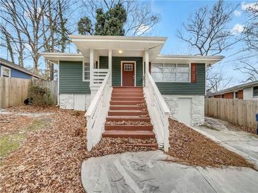 Charming home with a welcoming front porch, complemented by a well-maintained yard and inviting curb appeal at 136 Victor Nw Cir, Atlanta, GA 30314