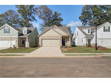 Charming new construction homes with sidewalks, manicured lawns, and inviting curb appeal on a bright, sunny day at 2208 Croghan Dr, Hampton, GA 30228