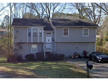 Split level home with light gray siding and a well-maintained front yard at 850 Sheppard Cv, Stone Mountain, GA 30083
