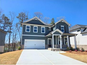 Charming two-story home features a two-car garage, craftsman-style details, and a welcoming front porch at 2359 Brown Dove Way (Lot 2), Grayson, GA 30017