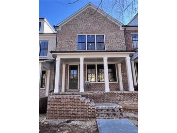 Charming brick townhome with covered entry and white columns at 1055 Dryden Ln # 10, Atlanta, GA 30319