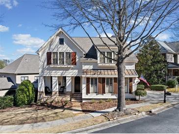 Charming two-story home with a welcoming front porch and meticulously landscaped yard at 3015 Woodvale Ct, Alpharetta, GA 30022