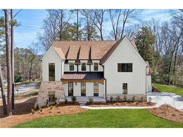 Stunning two-story home with a manicured lawn, stone accents, and a welcoming facade at 1445 Ashwoody Ne Ct, Atlanta, GA 30319