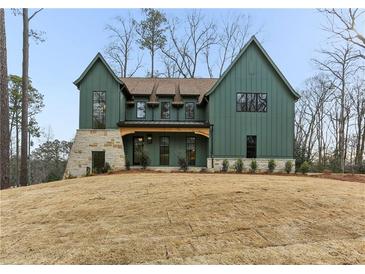 Striking two-story home featuring vertical siding, stone accents and professionally landscaped yard at 1445 Ashwoody Ne Ct, Atlanta, GA 30319