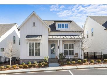 Charming two-story home features a light-colored facade, inviting entrance, and manicured landscaping at 982 Harvest Park Ln, Suwanee, GA 30024