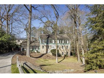 Charming two-story home featuring stone accents, lush landscaping, and a welcoming front entrance at 1742 Dunridge Ct, Dunwoody, GA 30338