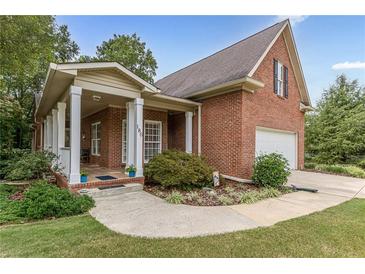 Charming brick home with a covered front porch and well-maintained landscaping at 180 Winecoff Dr, Fayetteville, GA 30214