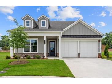 Charming one-story home with gray siding, white trim, a well-manicured lawn, and a two-car garage at 184 Vinca Nw Cir, Kennesaw, GA 30144