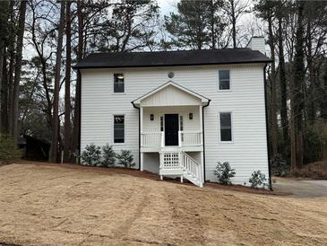Charming two-story home boasts fresh white siding and a welcoming front porch at 3663 Heatherwood Ne Dr, Marietta, GA 30066
