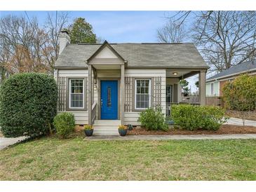 Charming cottage-style home with a blue front door and well-manicured landscaping at 49 Wyman Se St, Atlanta, GA 30317