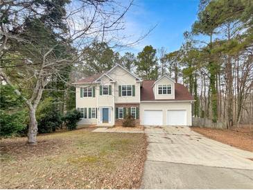 Charming two-story home featuring a well-manicured lawn and a two-car garage at 155 Mine Run, Fayetteville, GA 30215