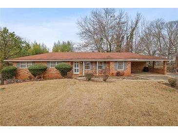 Charming single-story brick home featuring a well-maintained lawn and a convenient carport at 3948 Bright Star Rd, Douglasville, GA 30135