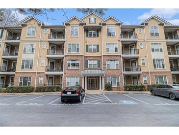 A stately condo building features a meticulously maintained facade and well-manicured landscaping at 2201 Stratford Commons, Decatur, GA 30033