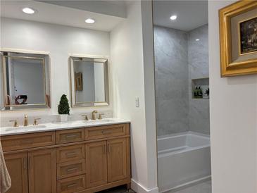 Elegant bathroom features a double vanity with gold fixtures and a separate shower/tub at 3093 Colonial Way # B, Atlanta, GA 30341
