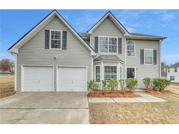 Charming two-story home featuring a two-car garage and well-maintained landscaping at 3414 Bench Ave, Atlanta, GA 30349