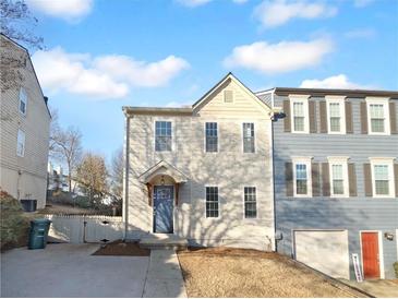 Charming two-story home features a blue front door and a well-manicured lawn at 61 Barrington Pl, Marietta, GA 30066