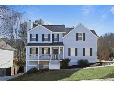 Charming two-story home with a covered porch and well-manicured front lawn at 4085 Amberly Nw Grn, Kennesaw, GA 30144