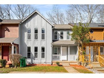 Charming townhome featuring a gray facade, front porch, and large windows at 846 Brandy Oaks Ln, Stone Mountain, GA 30088