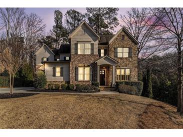 Charming multi-story home featuring brick, stone, and shake siding plus manicured landscaping at 6304 Long Island Drive, Sandy Springs, GA 30328