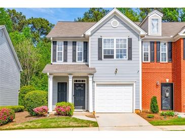 Charming two-story home with a well-maintained lawn and attached garage at 485 Lantern Wood Dr, Scottdale, GA 30079