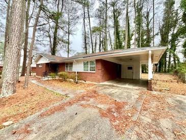 Charming single-story brick home with a carport and mature trees at 1905 Fort Valley Sw Dr, Atlanta, GA 30311