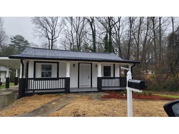 Charming renovated single-story home featuring a covered front porch and black and white accents at 2322 Ewing Sw St, Atlanta, GA 30331