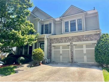 Two-story home with stone accents, an attached two-car garage and mature landscaping at 3740 Crowchild Dr, Cumming, GA 30041