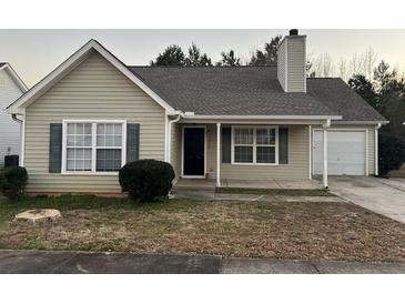 Charming single-story home with neutral siding, attached garage, and well-maintained landscaping at 4735 Jackam Ridge Ct, Lithonia, GA 30038