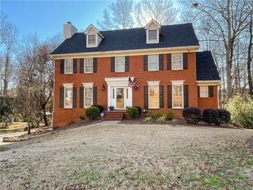 Charming brick two-story home with a manicured lawn and classic American architectural details at 2120 Chartwell Ct, Lawrenceville, GA 30043