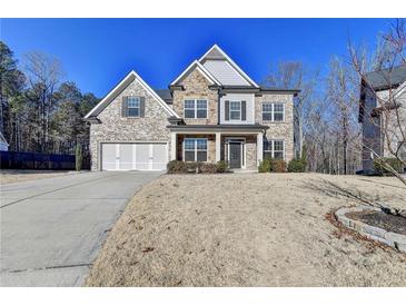 Charming two-story home featuring a combination of brick, stone, and siding, with an attached two-car garage at 3608 Crayton Glen Way, Buford, GA 30519
